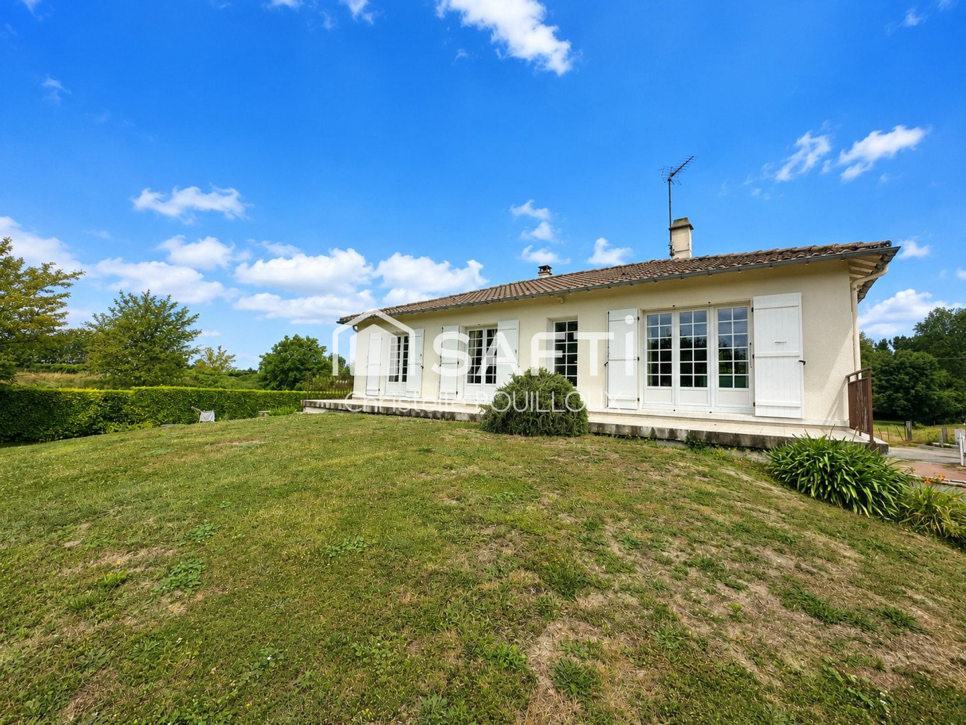 Maison semi-enterrée, 3 chambres, hangar et terrain arboré.