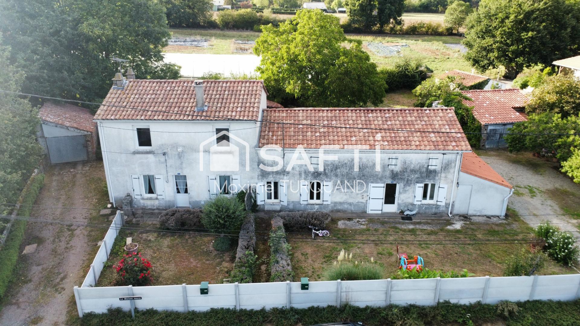 Ensemble immobilier comprenant 2 logements dont 1 loué + terrains + dépendances.